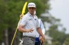 J.T. Poston waves after making a putt on the first hole during the final round of the RBC Heritage golf tournament, Sunday, April 21, 2024, in Hilton Head Island, S.C. (AP Photo/Chris Carlson)