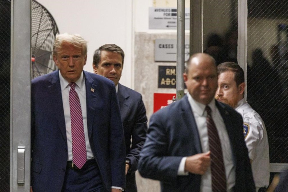 Republican presidential candidate, former President Donald Trump approaches the media at Manhattan Criminal Court in New York, Friday, April 19, 2024. (Sarah Yenesel/Pool Photo via AP)