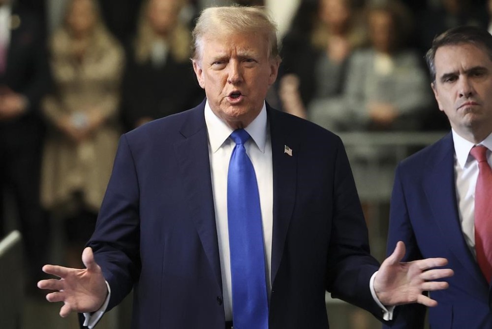 Former president Donald Trump speaks upon arriving at Manhattan criminal court, Monday, April 22, 2024, in New York. Opening statements in Donald Trump's historic hush money trial are set to begin. Trump is accused of falsifying internal business records as part of an alleged scheme to bury stories he thought might hurt his presidential campaign in 2016. (AP Photo/Yuki Iwamura, Pool)