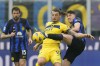 FILE - Inter Milan's Alessandro Bastoni, right, and Verona's Milan Duric challenge for the ball during the Serie A soccer match between Inter Milan and Hellas Verona at the San Siro Stadium in Milan, Italy, Jan. 6, 2024. A 2-1 victory over AC Milan in the derby has given Inter Milan a 20th Serie A title and a second star on the team shirts. (AP Photo/Antonio Calanni, File)