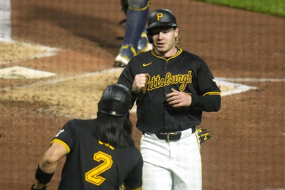 Pittsburgh Pirates' Jack Suwinski, center, celebrates with Connor Joe after both scored on a single by Oneil Cruz off Milwaukee Brewers relief pitcher Hoby Milner during the sixth inning of a baseball game in Pittsburgh, Monday, April 22, 2024. (AP Photo/Gene J. Puskar)