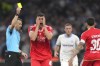 Referee Felix Zwayer shows a yellow card to Benfica's Antonio Silva during the Europa League quarter final second leg soccer match between Olympique de Marseille and SL Benfica at the Velodrome stadium in Marseille, south of France, Thursday, April 18, 2024. (AP Photo/Daniel Cole)
