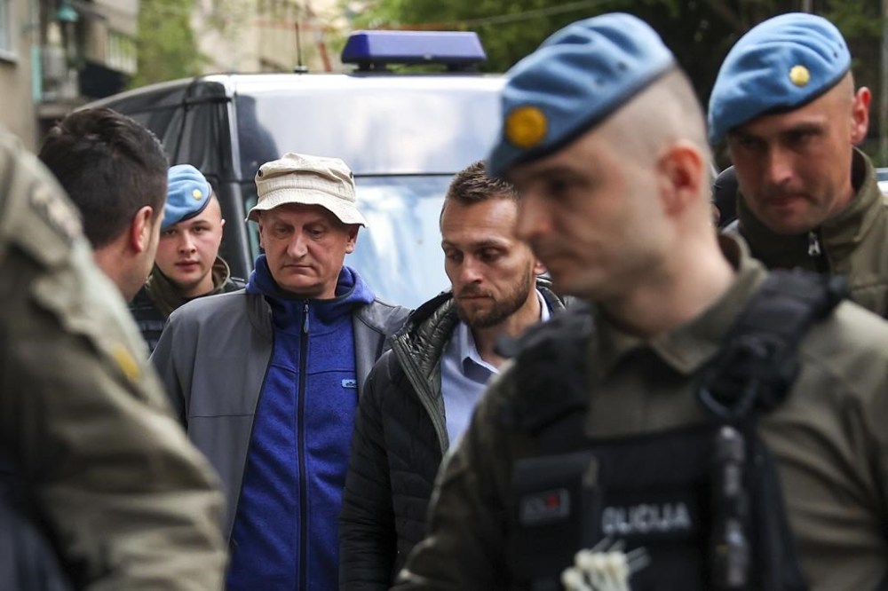 Members of the special police unit of Canton Sarajevo escort Vahidin Munjic, chief of the Federal Police, during an operation codenamed