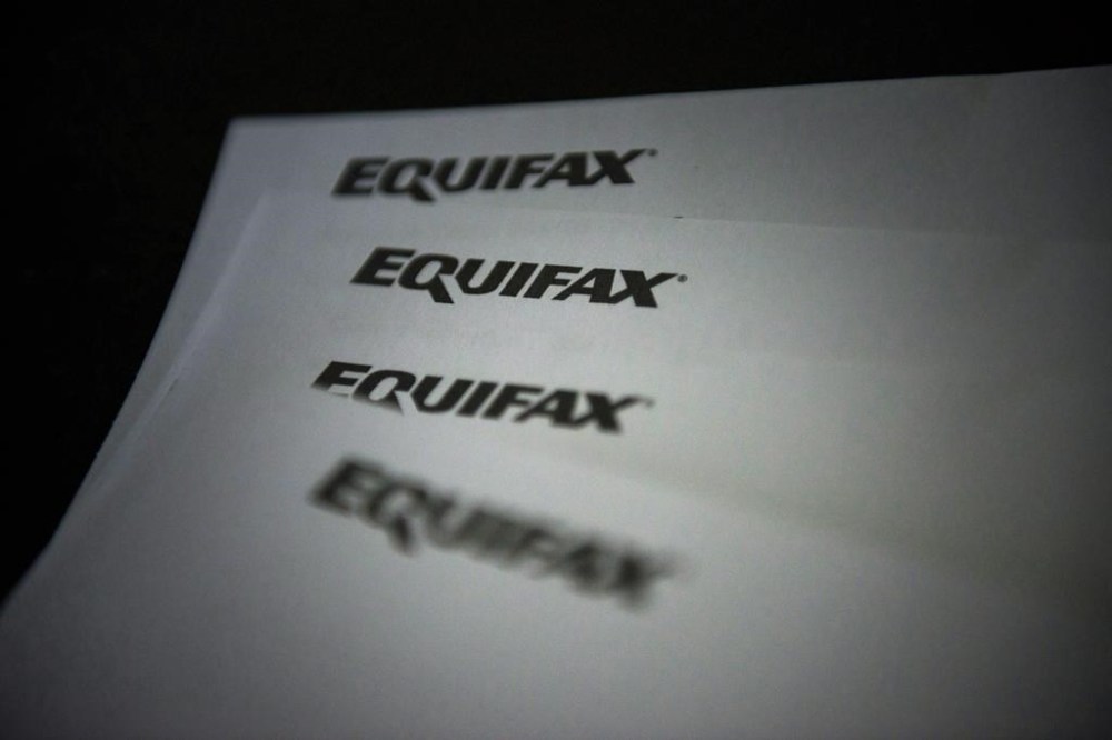 Equifax Canada says it's exploring how rent data could factor in to credit scores to help make credit and financial services accessible to more people. Equifax logos are shown on paper in Toronto on Oct.17, 2019. THE CANADIAN PRESS/Christopher Katsarov