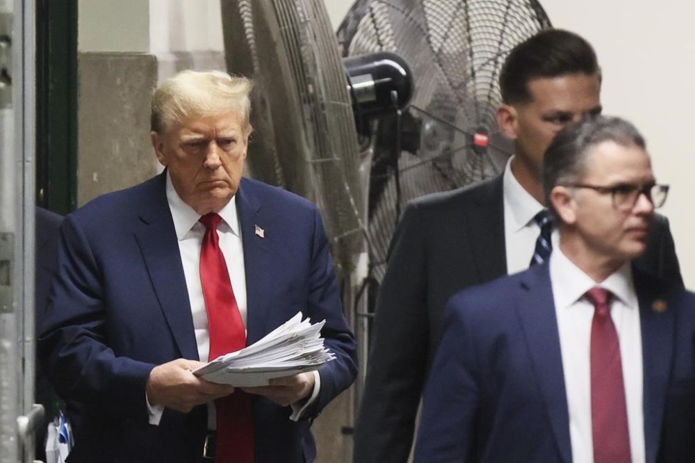 Republican presidential candidate and former President Donald Trump walks in Manhattan criminal court in New York, Tuesday, April 23, 2024. (Brendan McDermid/Pool Photo via AP)