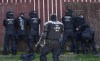 Hundreds of German local state police and federal police practice tactics in preparation for the European Championship in the village of Stützerbach, in Ilmenau, Germany, Tuesday, April 23, 2024. Germany hosts the European Championship from June 14 to July 14. Security is a priority with hundreds of thousands of fans expected for the 24-country soccer tournament. (AP Photo/Ebrahim Noroozi)