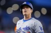 Los Angeles Dodgers designated hitter Shohei Ohtani jogs back to the dugout during the fifth inning of the team's baseball game against the Washington Nationals at Nationals Park, Tuesday, April 23, 2024, in Washington. (AP Photo/Alex Brandon)