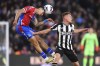 Crystal Palace's Daniel Munoz, left, heads the ball over Newcastle United's Harvey Barnes during a Premier League soccer match at Selhurst Park in London, Wednesday, April 24, 2024. (John Walton/PA via AP)