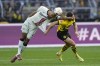 Leverkusen's Jonathan Tah, left, and Dortmund's Niclas Fuellkrug challenge for the ball during the German Bundesliga soccer match between Borussia Dortmund and Bayer Leverkusen in Dortmund, Germany, Sunday, April 21, 2024. (AP Photo/Martin Meissner)