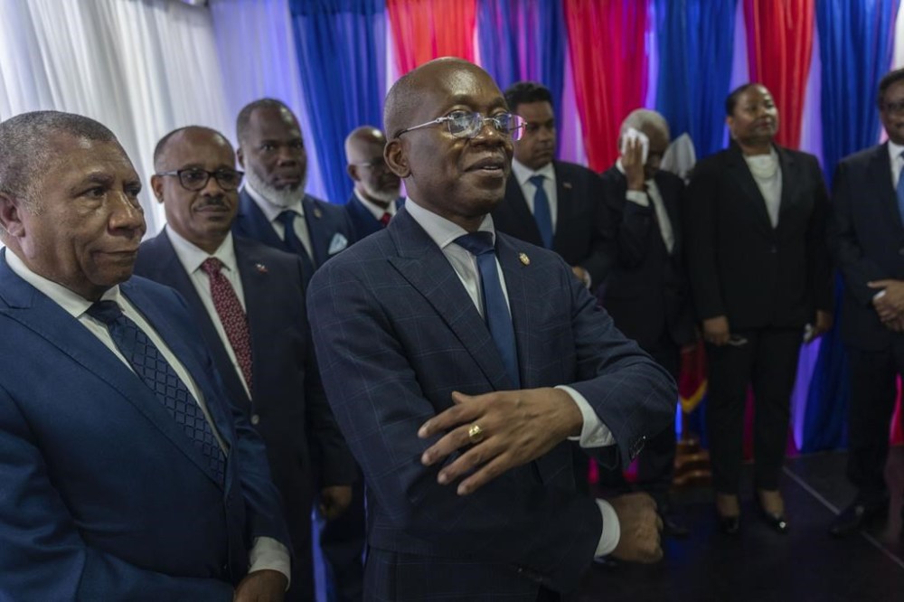 Michel Patrick Boisvert, center, who was named interim Prime Minister by outgoing Prime Minister Ariel Henry, attends the swearing-in ceremony of the transitional council tasked with selecting Haiti's new prime minister and cabinet, in Port-au-Prince, Haiti, Thursday, April 25, 2024. Boisvert was previously the economy and finance minister. (AP Photo/Ramon Espinosa)