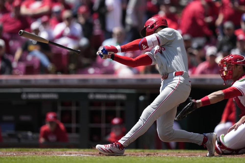 Philadelphia Phillies' Trea Turner loses the grip on his bat as he swings at a pitch in the first inning of a baseball game against the Cincinnati Reds, Thursday, April 25, 2024, in Cincinnati. The Phillies won 5-0. (AP Photo/Carolyn Kaster)