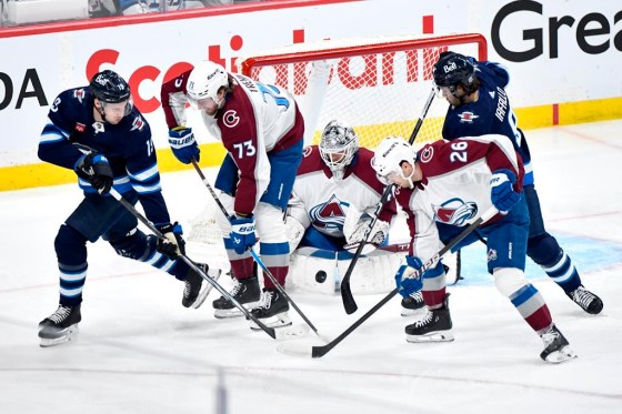 Colorado Avalanche goaltender Alexandar Georgiev (40) makes a save on a shot as Winnipeg Jets' David Gustafsson (19) and Alex Iafallo (9) look for the rebound in Game 2. (Fred Greenslade / The Canadian Press files)