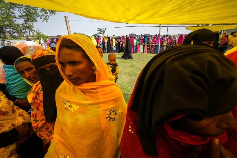 Women stand on queue to cast their votes in a polling station on the bank of the Brahmaputra river during the second round of voting in the six-week-long national election in Morigaon district, Assam, India, Friday, April 26, 2024. (AP Photo/Anupam Nath)