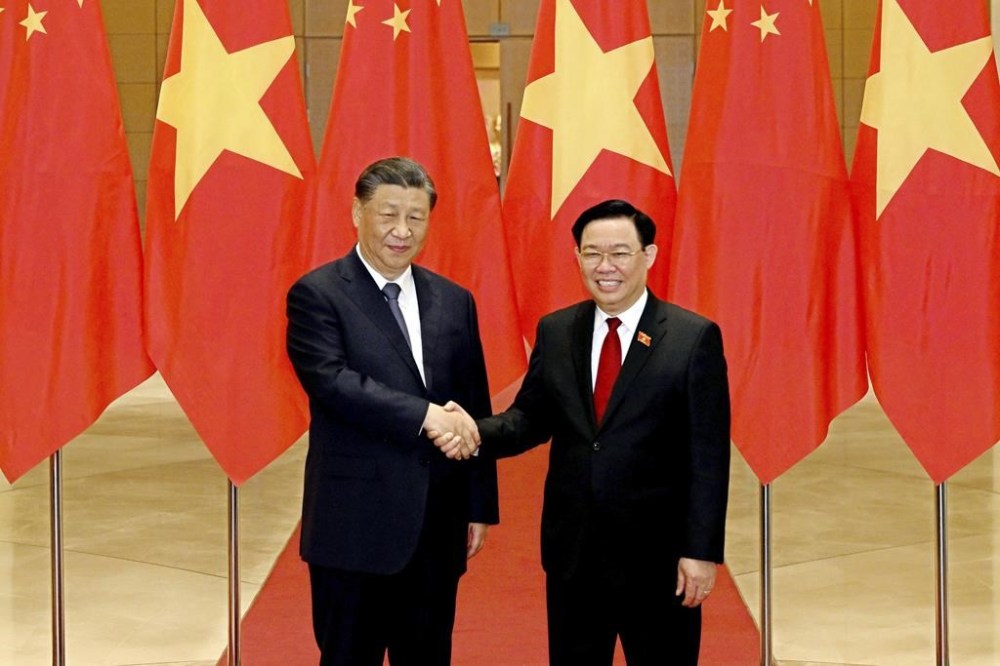 FILE - Chinese President Xi Jinping, left, and Vietnamese Chairman of the National Assembly Vuong Dinh Hue shake hands as they pose for a photo at the national assembly in Hanoi, Vietnam, Wednesday, Dec. 13, 2023. Vietnamese state media outlet VN Express reports that the head of Vietnam’s Parliament, Vuong Dinh Hue, has resigned. He is the latest member of senior government to leave office amid an ongoing anti-corruption campaign. (AP Photo/Minh Hoang, Pool, File)