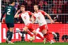 Bayern's Joshua Kimmich, center, and Harry Kane (9) celebrate after Kimmich scored during the Champions League quarter final second leg soccer match between Bayern Munich and Arsenal at the Allianz Arena in Munich, Germany, Wednesday, April 17, 2024. (Tom Weller/dpa via AP)