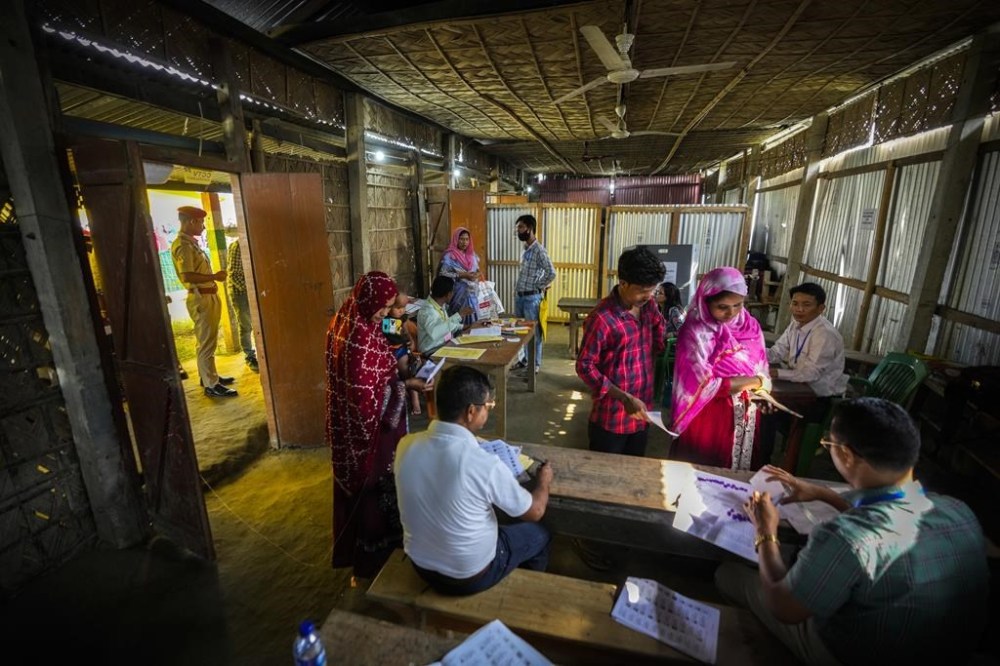 Voters line up to vote in a polling station during the second round of voting in the six-week-long national election in Morigaon district, Assam, India, Friday, April 26, 2024. (AP Photo/Anupam Nath)