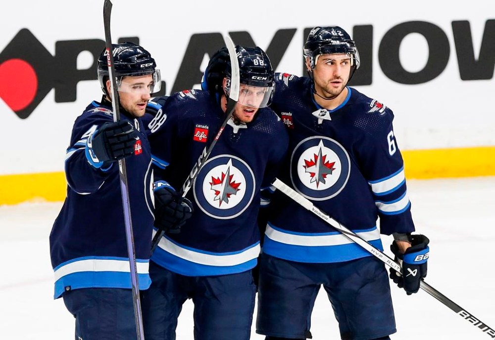 Winnipeg Jets' (left to right) Neal Pionk, Nate Schmidt and Nino Niederreiter celebrate Schmidt's goal against the Anaheim Ducks during second period NHL action in Winnipeg, Friday, March 15, 2024. Head coach Rick Bowness says that Schmidt will be in the lineup for Game 3 on Friday night and fellow blueliner Logan Stanley will sit.THE CANADIAN PRESS/John Woods
