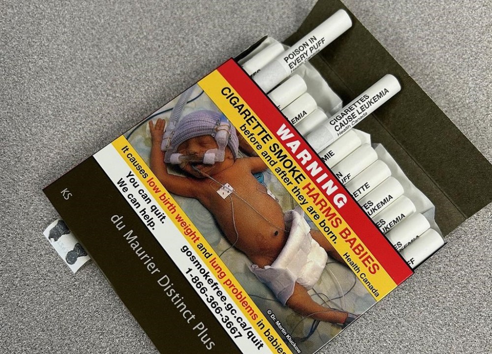 Canada has become the first country to sell cigarettes with health warnings printed directly on them to help people butt out or think twice about starting to smoke. A pack of cigarettes bearing exterior warning label and warnings on the filter tips of each individual cigarette is seen in Vancouver, B.C., Friday, April 26, 2024. THE CANADIAN PRES/Camille Bains