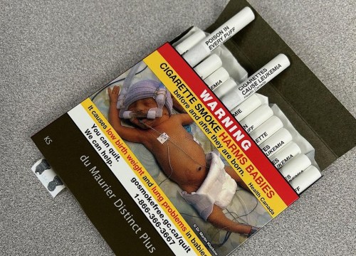 Canada has become the first country to sell cigarettes with health warnings printed directly on them to help people butt out or think twice about starting to smoke. A pack of cigarettes bearing exterior warning label and warnings on the filter tips of each individual cigarette is seen in Vancouver, B.C., Friday, April 26, 2024. THE CANADIAN PRES/Camille Bains
