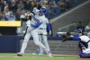Los Angeles Dodgers designated hitter Shohei Ohtani (17) hits a solo home run as Toronto Blue Jays catcher Danny Jansen (9) looks on during first inning Interleague MLB baseball action in Toronto on Friday, April 26, 2024. THE CANADIAN PRESS/Nathan Denette