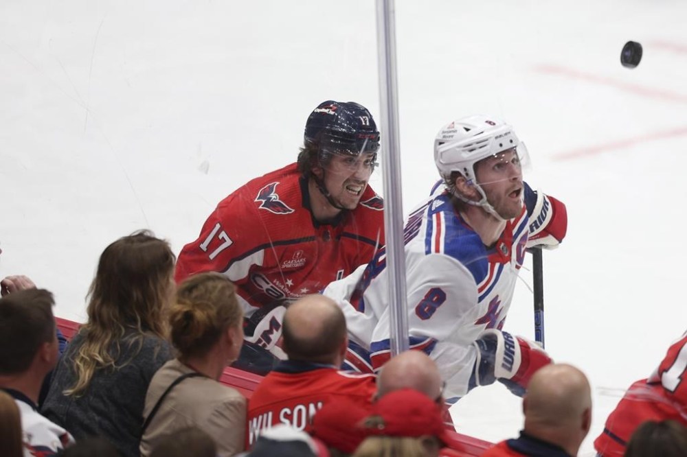 New York Rangers defenseman Jacob Trouba (8) and Washington Capitals center Dylan Strome (17) battle for puck possession during the third period in Game 3 of an NHL hockey Stanley Cup first-round playoff series, Friday, April 26, 2024, in Washington. (AP Photo/Tom Brenner)