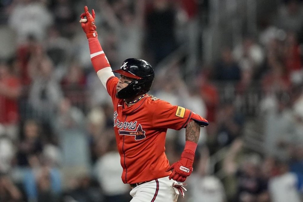 Atlanta Braves shortstop Orlando Arcia (11) celebrates his solo homer against the Cleveland Guardians during the eighth inning of a baseball game, Friday, April 26, 2024, in Atlanta. (AP Photo/Mike Stewart)