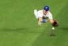 Toronto Blue Jays outfielder Daulton Varsho (25) miss plays a hit by Los Angeles Dodgers shortstop Mookie Betts during first inning interleague MLB baseball action in Toronto on Saturday, April 27, 2024. Betts was safe at third for the triple. THE CANADIAN PRESS/Chris Young
