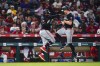 Minnesota Twins' Max Kepler, right, celebrates his solo home run with third base coach Tommy Watkins during the sixth inning of the team's baseball game against the Los Angeles Angels, Saturday, April 27, 2024, in Anaheim, Calif. (AP Photo/Ryan Sun)