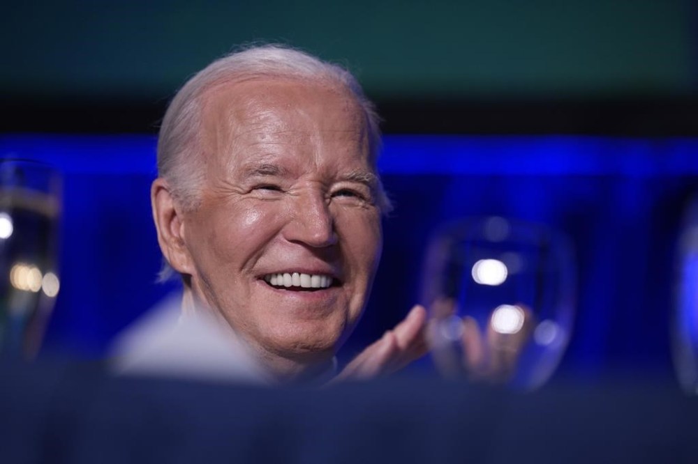 President Joe Biden laughs as host Colin Jost speaks at the White House Correspondents' Association Dinner at the Washington Hilton, Saturday, April 27, 2024, in Washington. (AP Photo/Manuel Balce Ceneta)