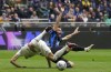 Torino's Nikola Vlasic, left and Inter Milan's Nicolo Barella tangle during a Serie A soccer match between Inter Milan and Torino at the San Siro stadium in Milan, Italy, Sunday, April 28, 2024. (AP Photo/Luca Bruno)