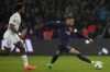 PSG's Kylian Mbappe gets away from Le Havre's Yoann Salmier during the French League One soccer match between Paris Saint-Germain and Le Havre at the Parc des Princes in Paris, Saturday, April 27, 2024. (AP Photo/Thibault Camus)