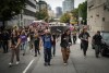Drug user advocates are raising concerns over British Columbia's request for Health Canada to give police power to step in when they see illicit drug use in public spaces, saying it may be a step backward in the fight against the deadly opioid crisis. Andrew Leavens, front left, and Carl Gladue, front right, carry an empty coffin during a march organized by the Vancouver Area Network of Drug Users (VANDU) to mark International Overdose Awareness Day, in Vancouver, B.C., Thursday, Aug. 31, 2023. THE CANADIAN PRESS/Darryl Dyck