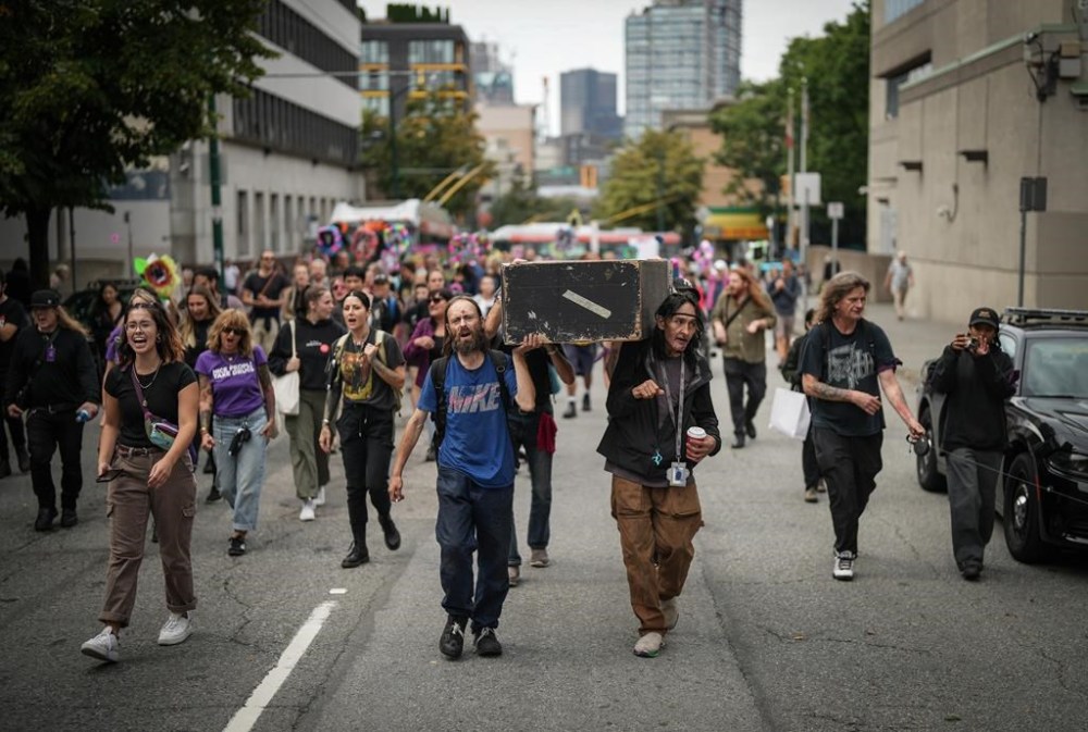 Drug user advocates are raising concerns over British Columbia's request for Health Canada to give police power to step in when they see illicit drug use in public spaces, saying it may be a step backward in the fight against the deadly opioid crisis. Andrew Leavens, front left, and Carl Gladue, front right, carry an empty coffin during a march organized by the Vancouver Area Network of Drug Users (VANDU) to mark International Overdose Awareness Day, in Vancouver, B.C., Thursday, Aug. 31, 2023. THE CANADIAN PRESS/Darryl Dyck