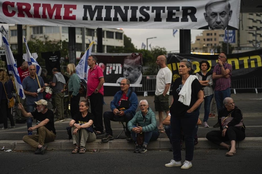 People protest against Israeli Prime Minister Benjamin Netanyahu's government in Tel Aviv, Israel, Saturday, April 27, 2024. (AP Photo/Ohad Zwigenberg)