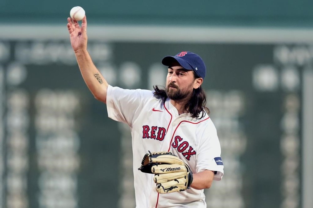 Singer/songwriter Noah Kahan throws a ceremonial first pitch before a baseball game between the Boston Red Sox and the Chicago Cubs, Sunday, April 28, 2024, in Boston. (AP Photo/Michael Dwyer)