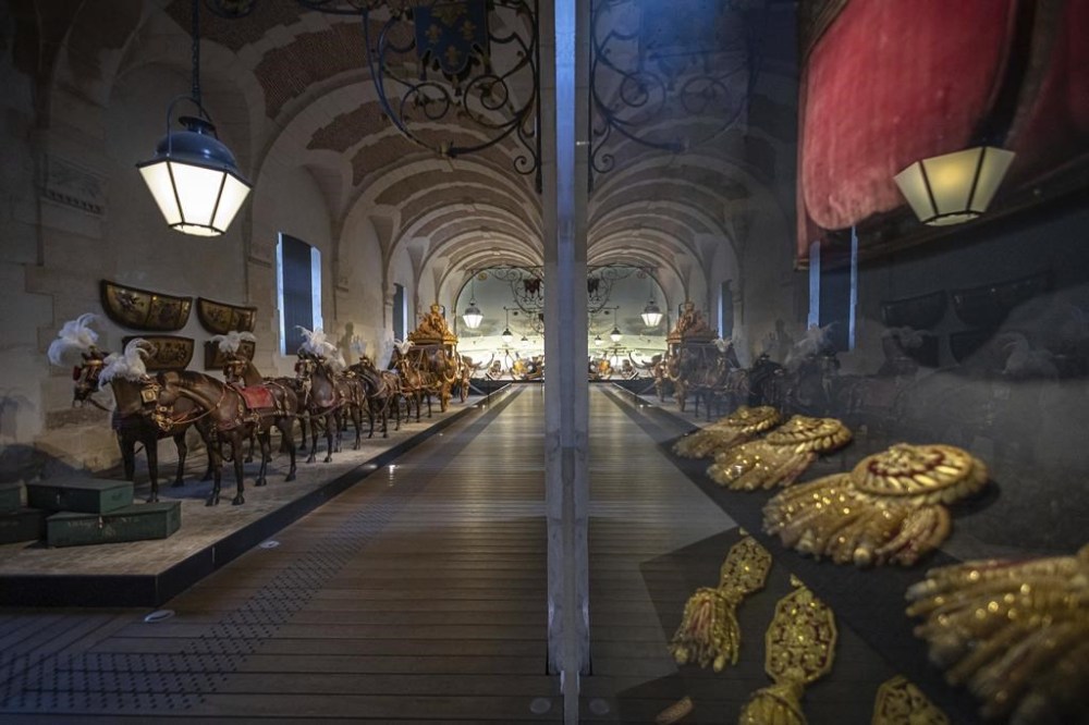 The gallery of Coaches in the Great Stables, in Versailles, Thursday, April 25, 2024. Gallery of Coaches, which contains one of the largest collections of coaches in Europe. Commissioned by King Louis XIV, the stables have been built from 1679 to 1682 opposite to the palace's main entrance. (AP Photo/Aurelien Morissard)