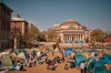 People listen to a speaker at a pro-Palestinian encampment, advocating for financial disclosure and divestment from all companies tied to Israel and calling for a permanent cease-fire in Gaza, inside the campus of Columbia University, Sunday, April 28, 2024, in New York. (AP Photo/Andres Kudacki)