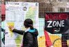 A pro-Palestinian activist looks at a map of Palestine taped to the fencing around their encampment on McGill University's campus in Montreal, Monday, April 29, 2024. The University of Ottawa is warning pro-Palestinian student activists who are following the lead of some American and Canadian post-secondary students and setting up camp today on university property that their protest can face serious consequences.THE CANADIAN PRESS/Christinne Muschi