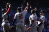 The Minnesota Twins celebrate after their win over the Los Angeles Angels in a baseball game, Sunday, April 28, 2024, in Anaheim, Calif. (AP Photo/Ryan Sun)