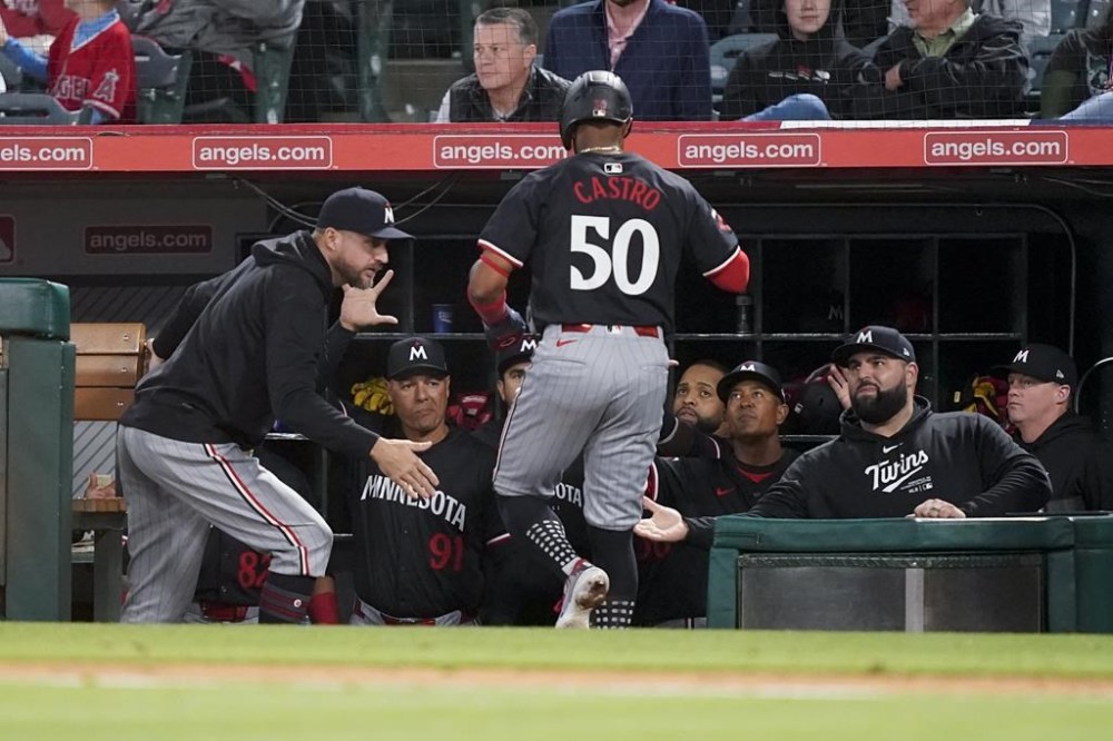 Minnesota Twins' Willi Castro (50) is congratulated in the dugout after scoring off a single hit by Ryan Jeffers during the fifth inning of a baseball game against the Los Angeles Angels, Friday, April 26, 2024, in Anaheim, Calif. (AP Photo/Ryan Sun)