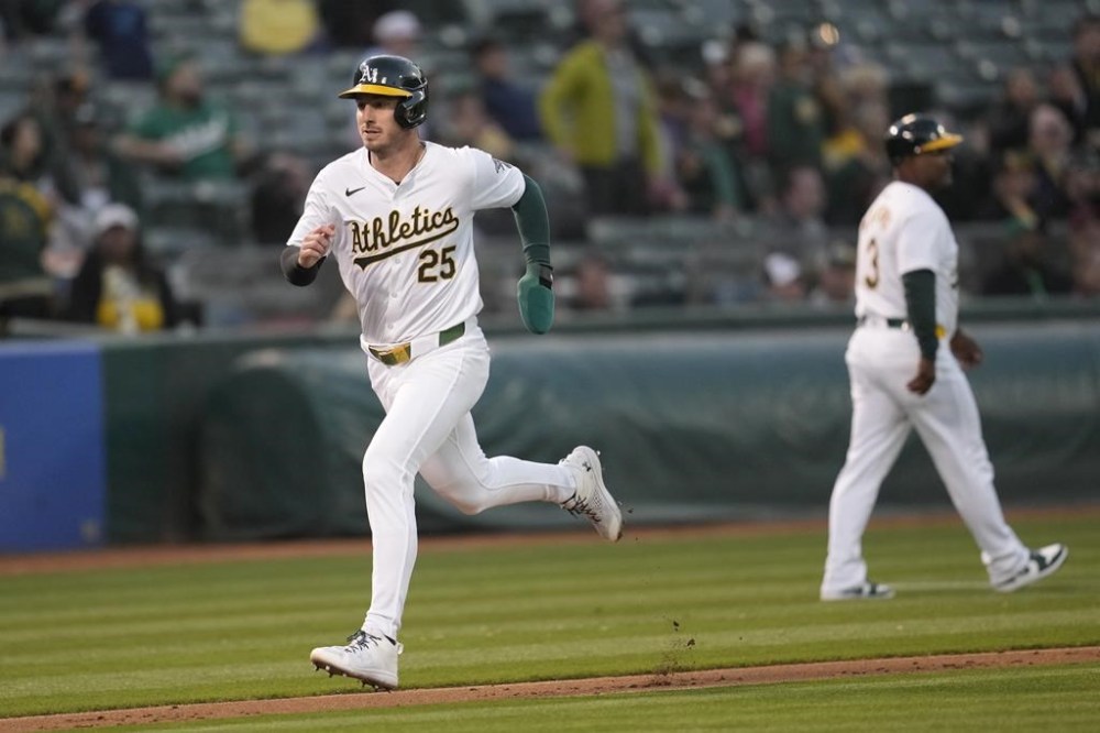 Oakland Athletics' Brent Rooker (25) runs home to score during the fourth inning of a baseball game against the Pittsburgh Pirates in Oakland, Calif., Monday, April 29, 2024. (AP Photo/Jeff Chiu)