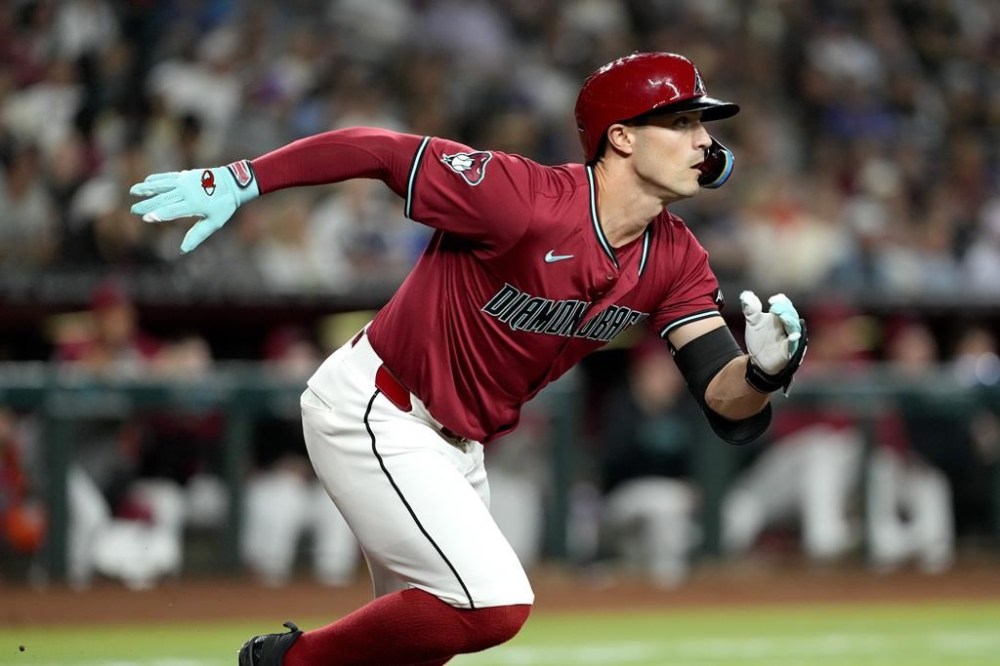 Arizona Diamondbacks' Randal Grichuk runs on his base hit against the Los Angeles Dodgers during the fourth inning of a baseball game, Monday, April 29, 2024, in Phoenix. (AP Photo/Matt York)