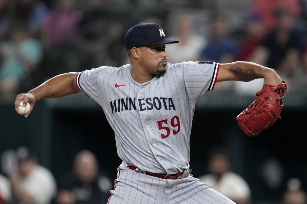 FILE - Minnesota Twins relief pitcher Jhoan Duran throws to the Texas Rangers in the ninth inning of a baseball game, Friday, Sept. 1, 2023, in Arlington, Texas. The Minnesota Twins reinstated closer Jhoan Duran from the 15-day injured list on Tuesday, April 30, 2024, after a strained right oblique muscle kept him out of the team's first 28 games.(AP Photo/Tony Gutierrez, File)
