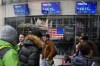 FILE - Pedestrians walk past the Nasdaq building as the stock price of Trump Media & Technology Group Corp. is displayed on screens, March 26, 2024, in New York. A Delaware judge on Tuesday, April 30, granted a request by attorneys for Donald Trump and Trump Media & Technology Group, parent company of his Truth Social platform, to slow down a lawsuit filed by two cofounders of the company. (AP Photo/Frank Franklin II, File)