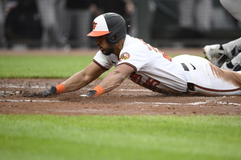Baltimore Orioles' Anthony Santander slides home to score during the second inning of a baseball game against the New York Yankees, Tuesday, April 30, 2024, in Baltimore. Santander scored from second base on a fielders choice by Orioles' Jordan Westburg and a throwing error by Yankees second baseman Gleyber Torres. (AP Photo/Nick Wass)