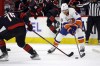 New York Islanders' Hudson Fasching (20) tries to moves the puck around Carolina Hurricanes' Brady Skjei (76) during the first period in Game 5 of an NHL hockey Stanley Cup first-round playoff series in Raleigh, N.C., Tuesday, April 30, 2024. (AP Photo/Karl B DeBlaker)