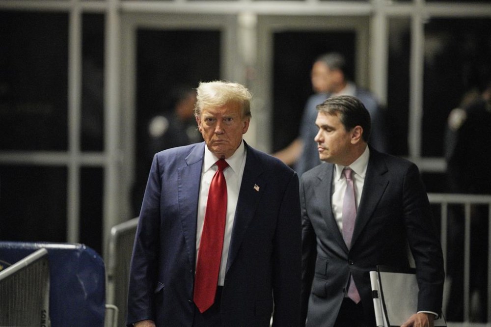 Former President Donald Trump walks outside the courtroom of his trial at Manhattan criminal court, Tuesday, April 30, 2024, in New York. His attorney, Todd Blanche, is on the right. (Curtis Means/Pool Photo via AP)