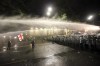 Riot police use a water cannon during an opposition protest against 