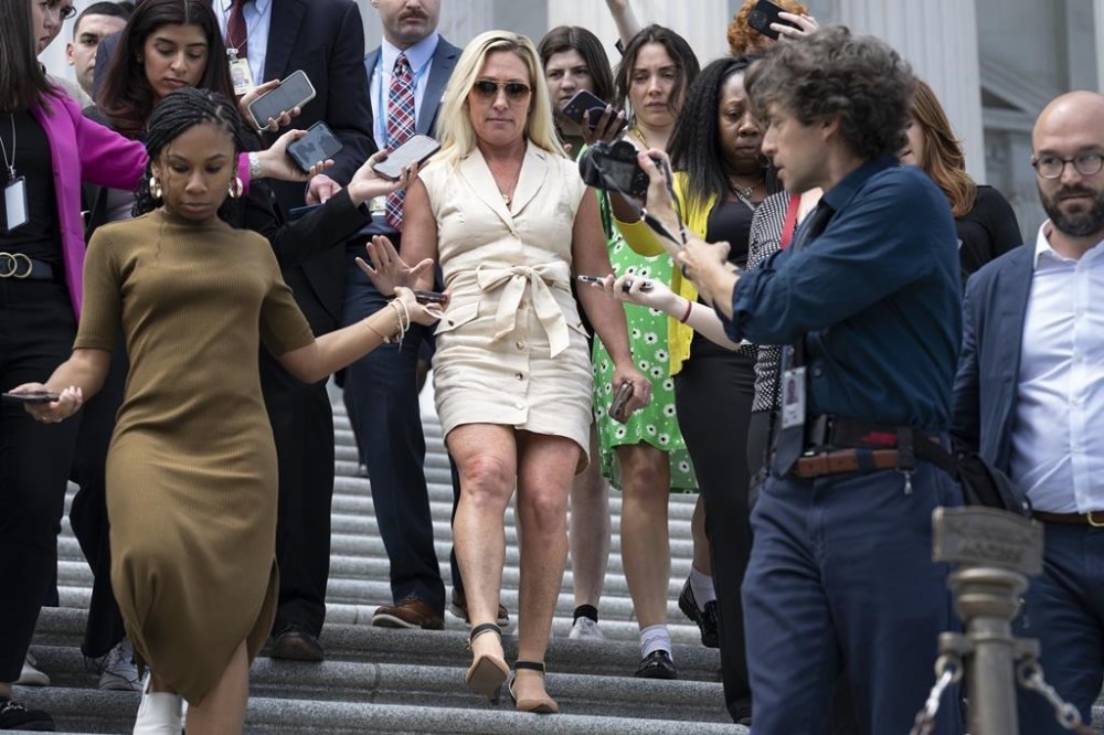 Rep. Marjorie Taylor Greene, R-Ga., is followed by reporters as she walks down the steps at the Capitol in Washington, Tuesday, April 30, 2024. (AP Photo/J. Scott Applewhite)