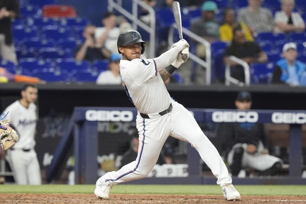 Miami Marlins Dane Myers hits a single to bring in two runs during the eighth inning of a baseball game against the Colorado Rockies, Wednesday, May 1, 2024, in Miami. (AP Photo/Marta Lavandier)